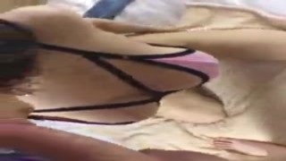 A sexy Asian babe with massive tits is seen in a leaked video