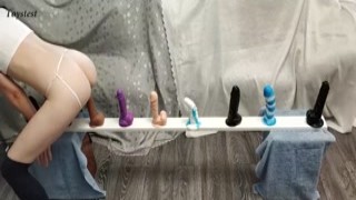 tiny babe rubs her little clit and slowly inserts each of her dildos, moaning as she tests them all