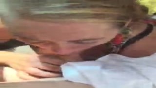 The slutty chick stood there with a big grin on her face, her massive tits hanging out as she sucked the guys cock in front of everyone