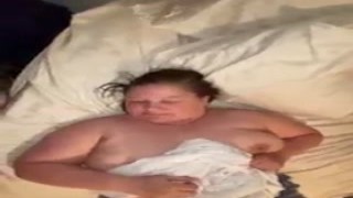 The plump wife bent over the bed with her big, juicy tits hanging out