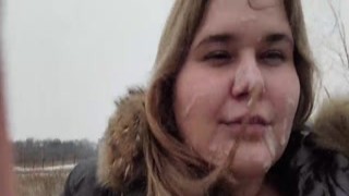 The chubby girl was lying down on the warm grass, her mouth stuffed with cock