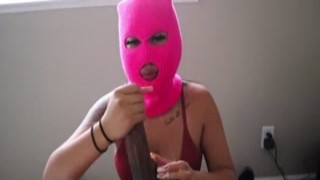 The little Asian girl in the ski mask was on her knees before the huge black man